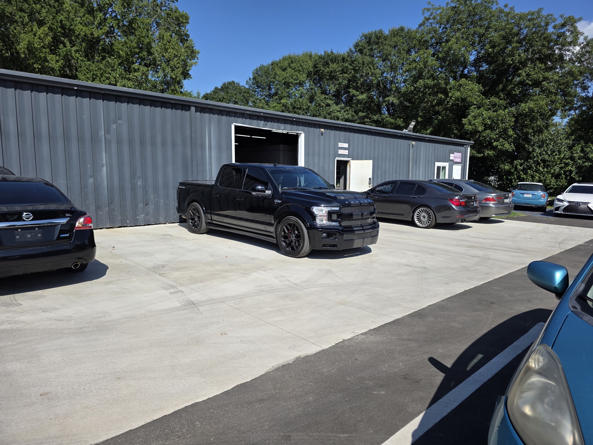Our shop building on Machine Dr with a bay door open