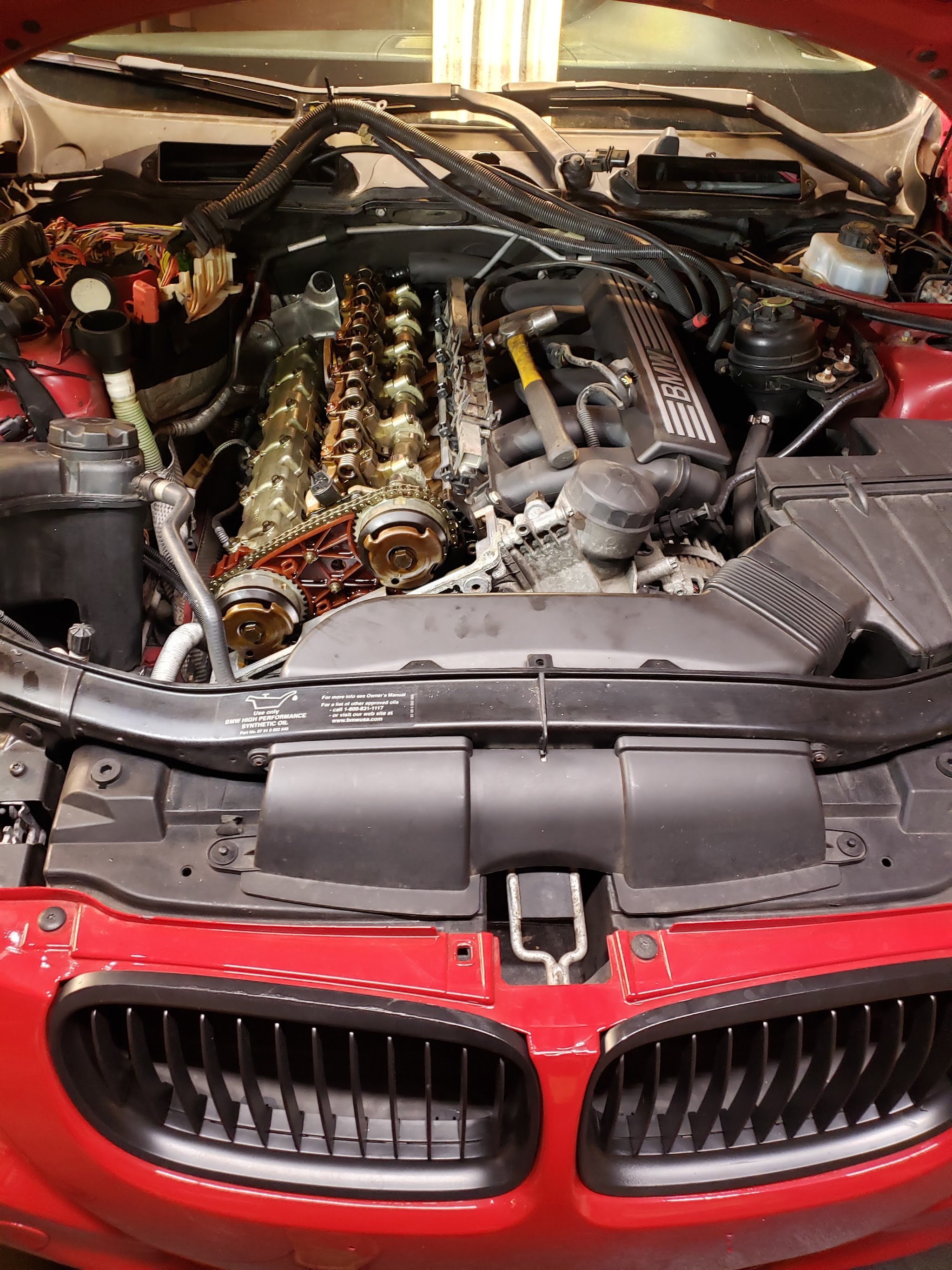 An open engine bay with the valve cover off